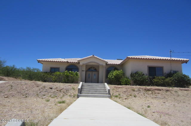 555 Row Court Rio Rico, AZ 85648 - Photo 1 of 25 a front view of a house with a yard