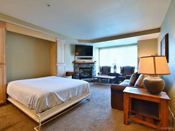 a bedroom with a bed and a flat screen tv