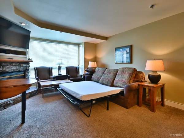 a bathroom with a sink a toilet a mirror and vanity