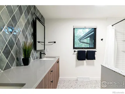 a bathroom with a sink a mirror and vanity