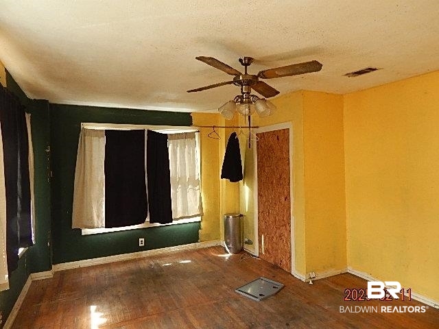 559 Williams Street Mobile, AL 36606 - Photo 4 of 20 Unfurnished room featuring hardwood / wood-style flooring, a textured ceiling, and ceiling fan