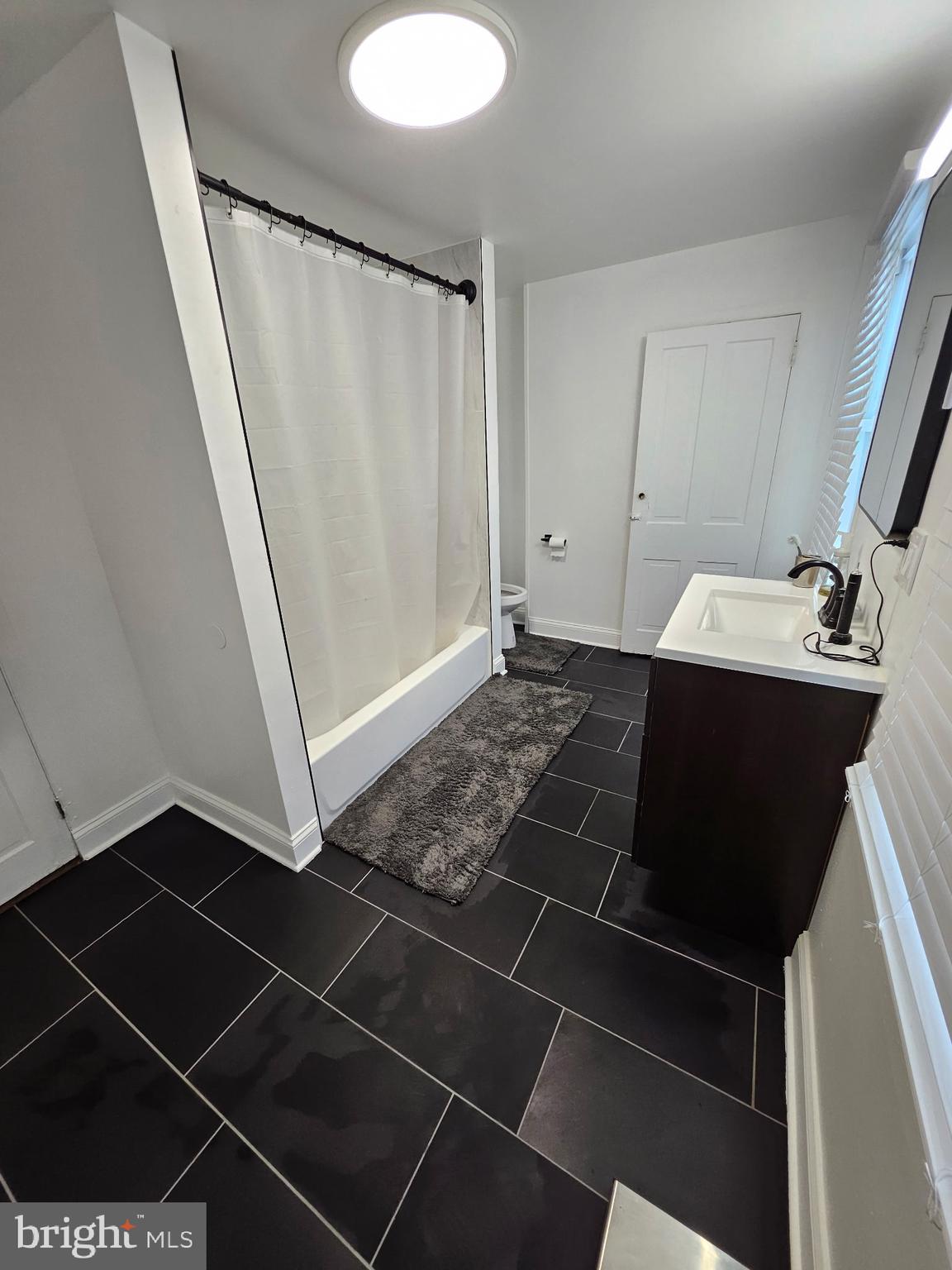 209 Mill Street Mount Holly, NJ 08060 - Photo 11 of 13 a bathroom with a sink and a mirror