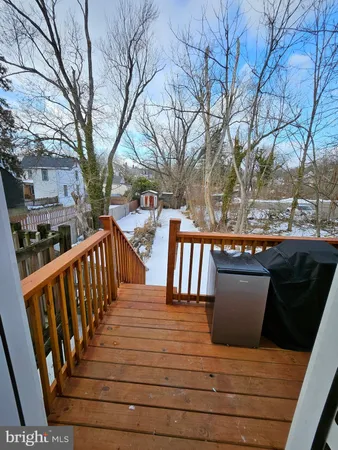 a view of deck with seating space and trees