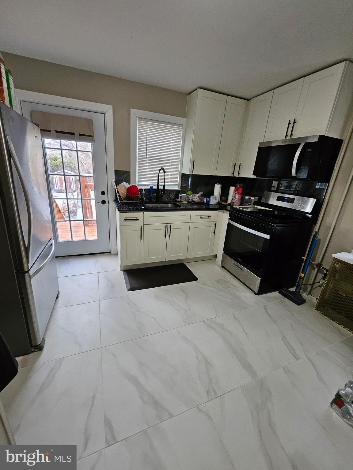 209 Mill Street Mount Holly, NJ 08060 - Photo 2 of 13 a kitchen with a sink a stove and cabinets