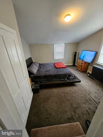 a bedroom with furniture and a window