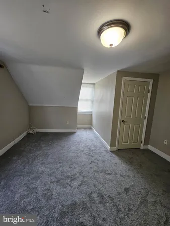 a view of a livingroom with wooden floor and window