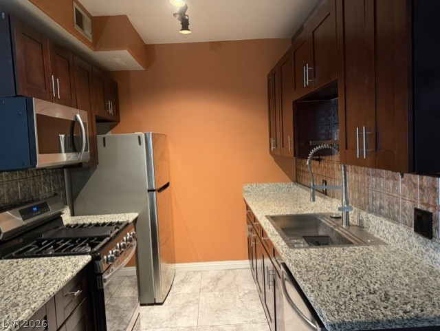 3318 North Decatur Boulevard, Unit 1163 Las Vegas, NV 89130 - Photo 14 of 35 A well-appointed kitchen showcasing elegant granite countertops and modern stainless steel appliances.