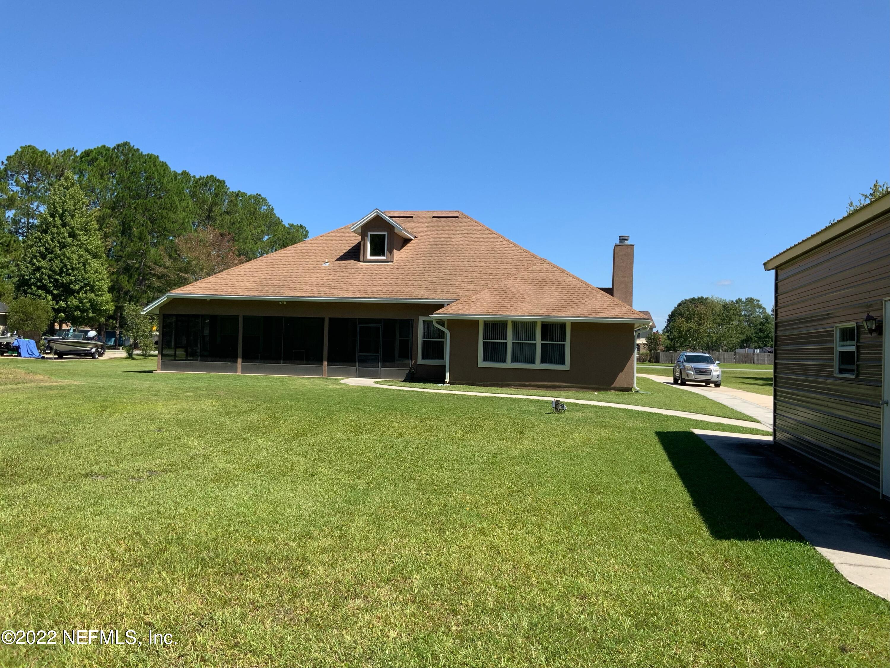 55244 Yellow Jacket Drive Callahan, FL 32011 - Photo 8 of 22 a front view of a house with a garden