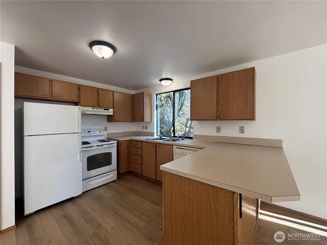 a kitchen with a white cabinets and white appliances
