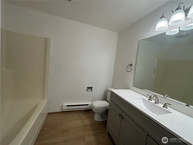 a bathroom with a sink toilet and a mirror