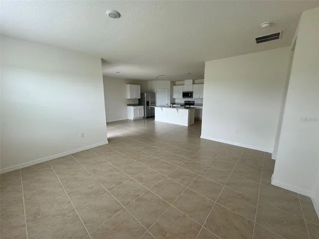 a view of a kitchen with a sink and a refrigerator