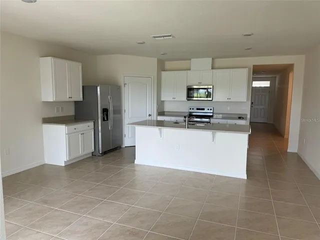 a kitchen with stainless steel appliances a refrigerator sink and stove