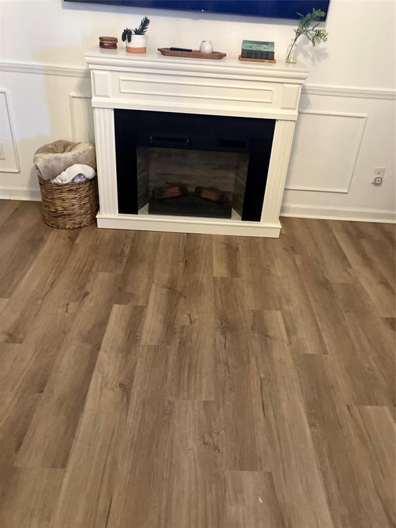 233 Church Road Stonewall, LA 71078 - Photo 22 of 32 Detailed view of a decorative wall, wainscoting, a fireplace, and wood finished floors