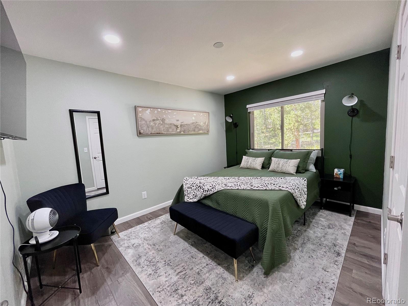 265 Caesar Road Black Hawk, CO 80422 - Photo 34 of 42 a bedroom with a bed and wooden floor