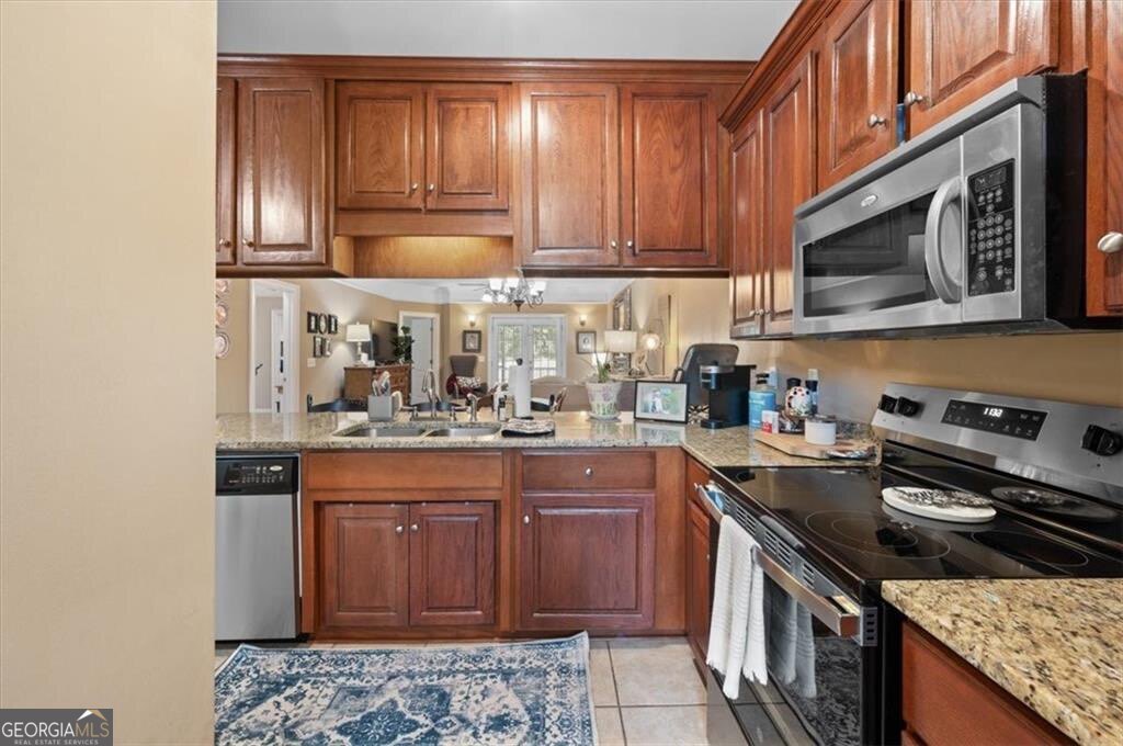 7272 Shellman Bluff Road Northeast, Unit 21 Townsend, GA 31331 - Photo 15 of 33 a kitchen with stainless steel appliances granite countertop a stove a sink and a microwave