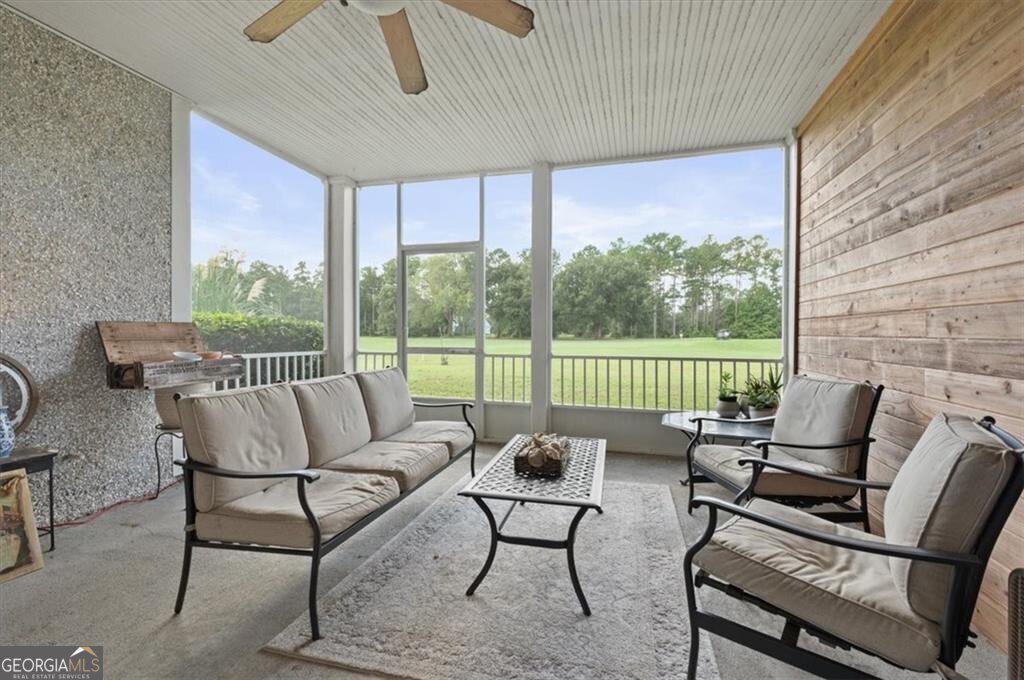 7272 Shellman Bluff Road Northeast, Unit 21 Townsend, GA 31331 - Photo 26 of 33 a roof deck with a couch and chairs