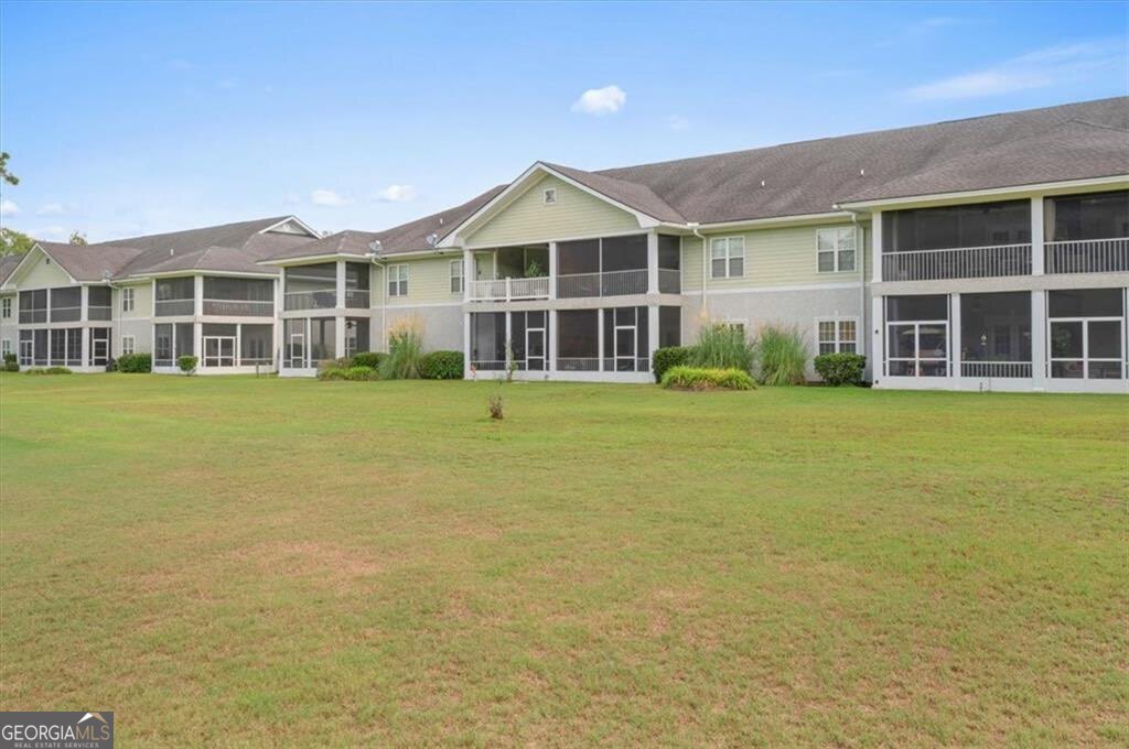 7272 Shellman Bluff Road Northeast, Unit 21 Townsend, GA 31331 - Photo 30 of 33 a front view of a building with a garden
