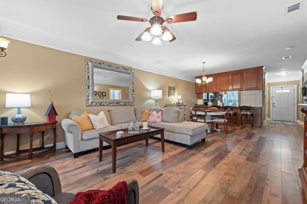 7272 Shellman Bluff Road Northeast, Unit 21 Townsend, GA 31331 - Photo 7 of 33 a living room with furniture and a wooden floor