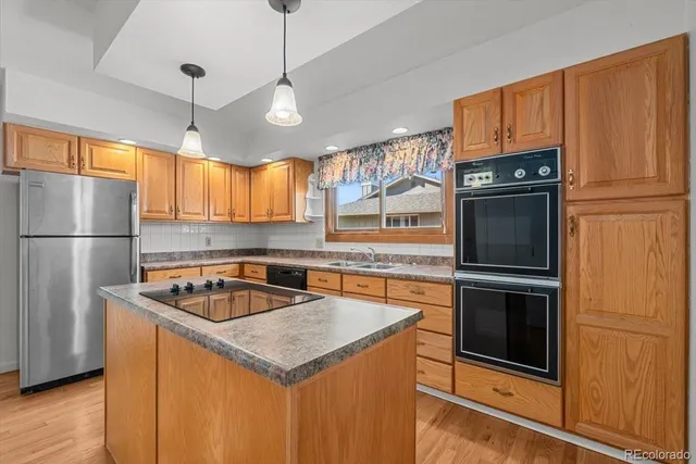 a view of a kitchen with wooden floor