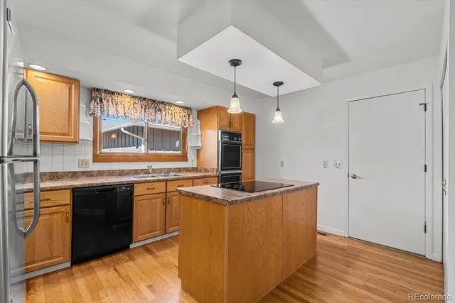 a kitchen with granite countertop a sink and cabinets
