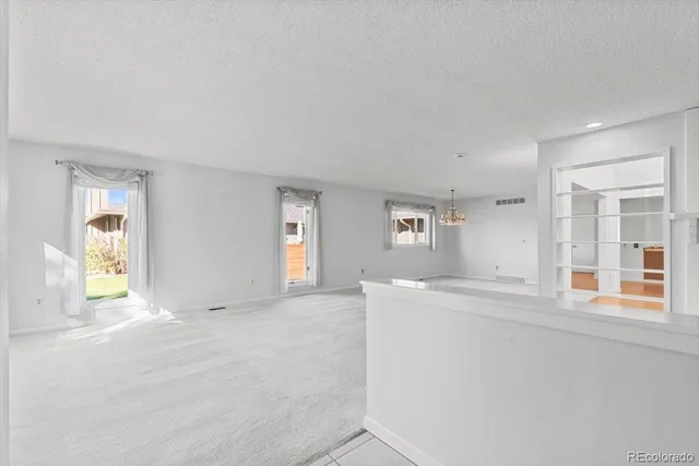 an empty room with windows and entrance