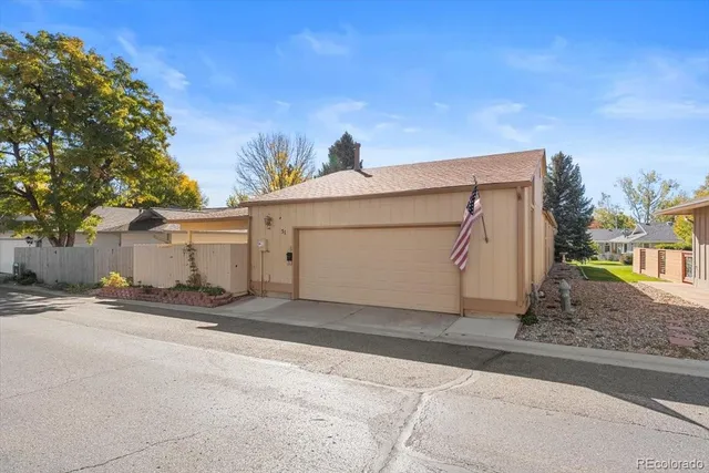 a view of a house with backyard and a tree