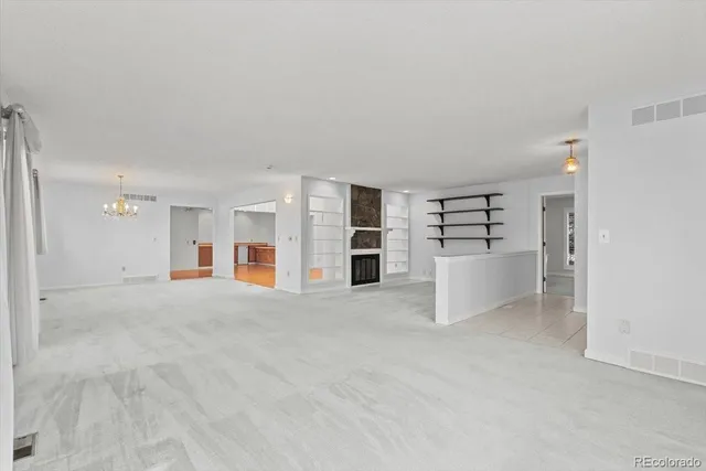 a view of an empty room with a kitchen