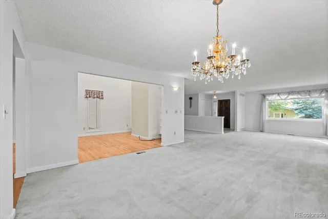 a view of a room with chandelier and windows