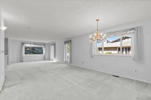 a view of a house with backyard and a tree