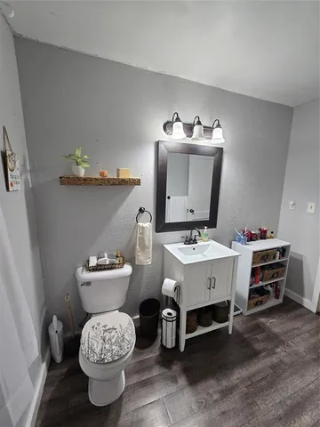 a view of bathroom with a toilet sink and mirror