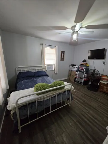 a bed room with wooden floor and furniture