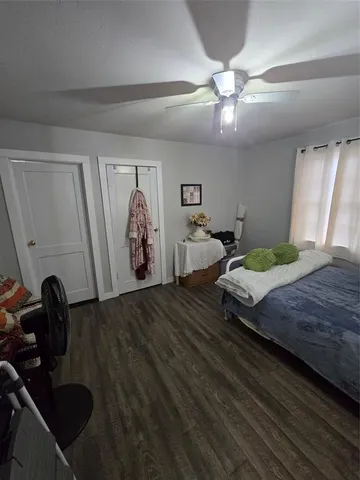 a bedroom with a bed and a ceiling fan