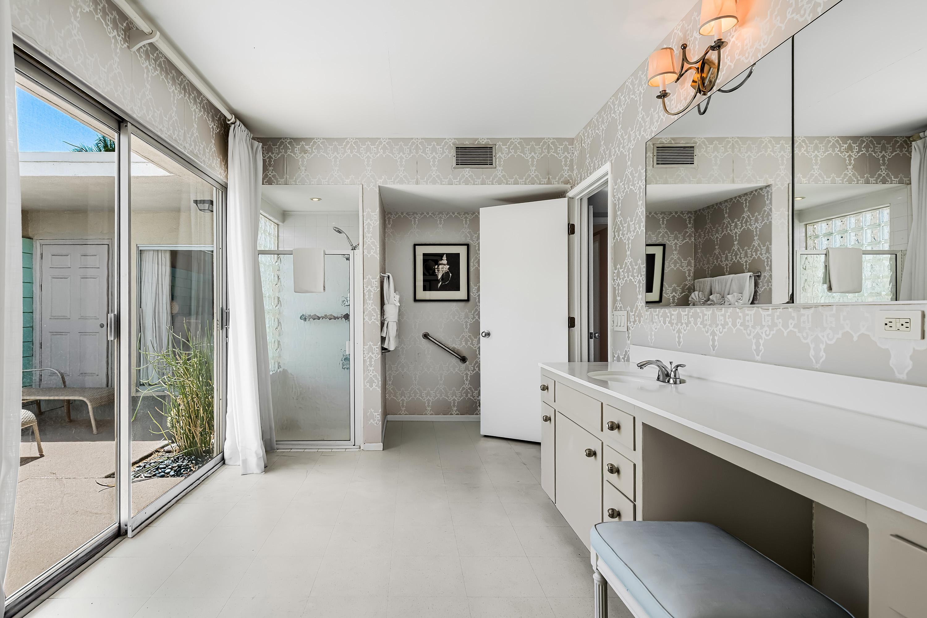 1855 Ramon Road, Unit 14 Palm Springs, CA 92264 - Photo 20 of 34 a bathroom with a double vanity sink mirror and shower