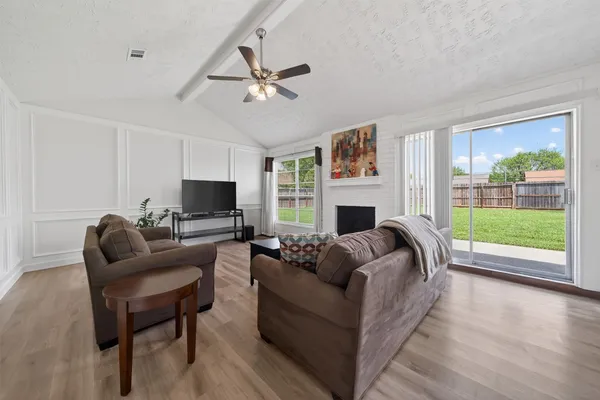 a living room with furniture a fireplace and a flat screen tv