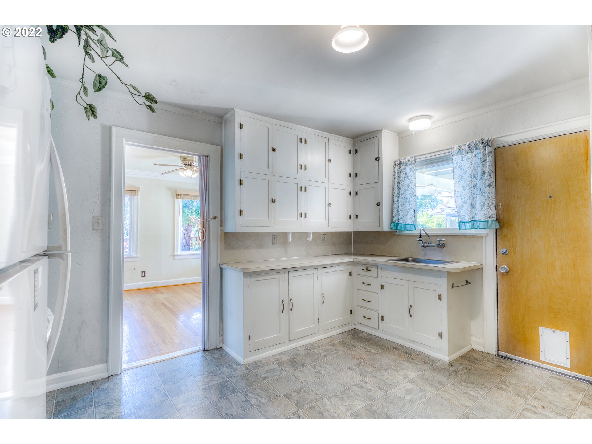 924 Chambers Street Eugene, OR 97402 - Photo 12 of 27 a kitchen with granite countertop white cabinets and refrigerator