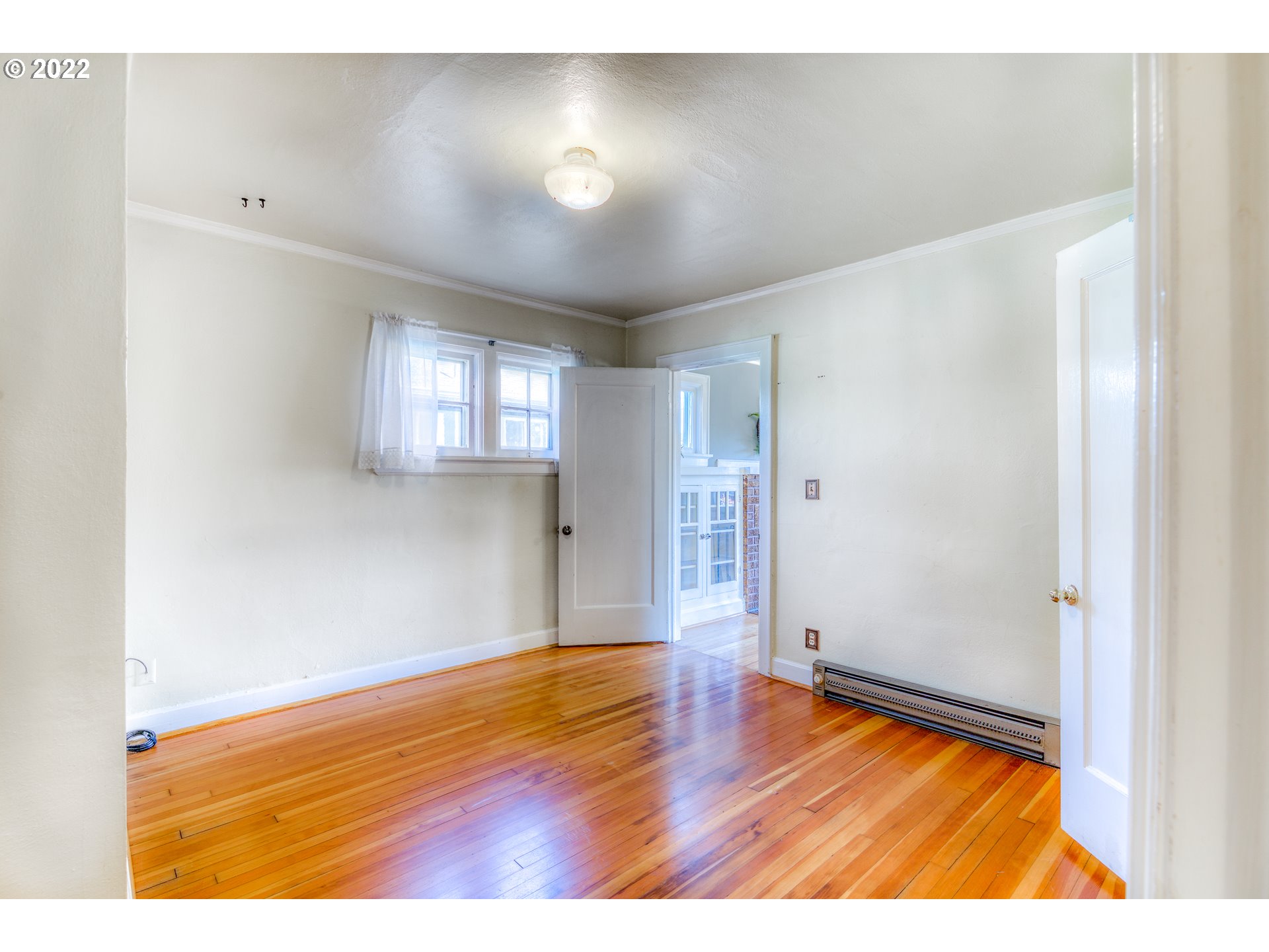 924 Chambers Street Eugene, OR 97402 - Photo 13 of 27 a view of empty room with wooden floor and fan