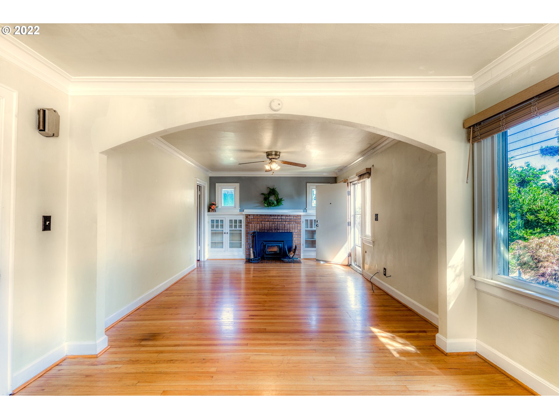 924 Chambers Street Eugene, OR 97402 - Photo 5 of 27 a view of an empty room with wooden floor fire place and windows