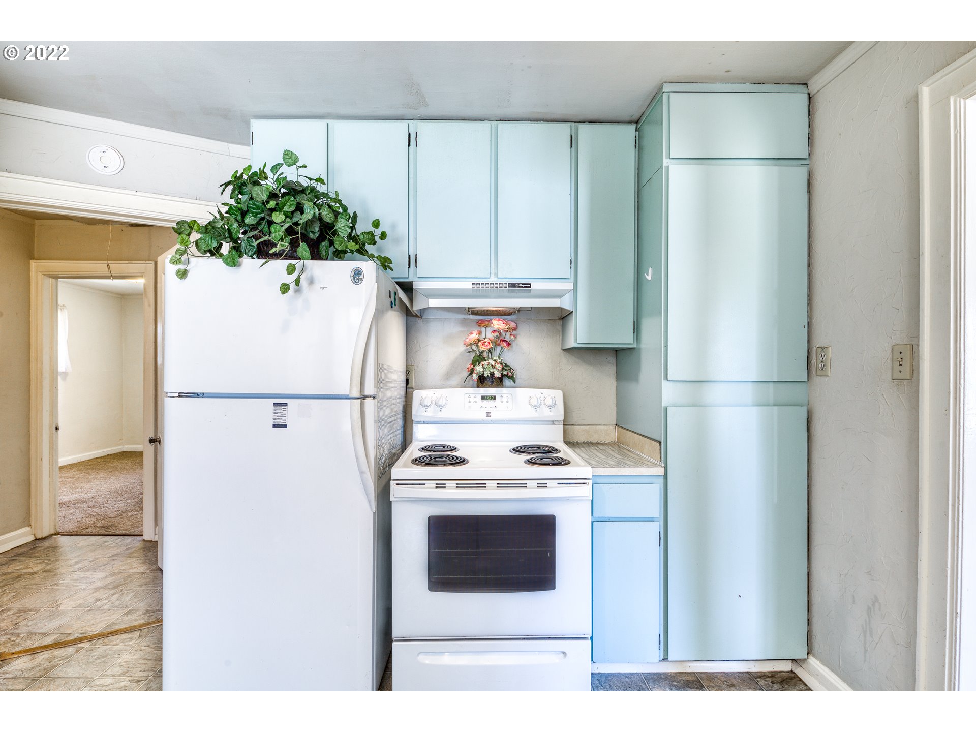 924 Chambers Street Eugene, OR 97402 - Photo 10 of 27 a white refrigerator freezer and a stove sitting inside of a kitchen