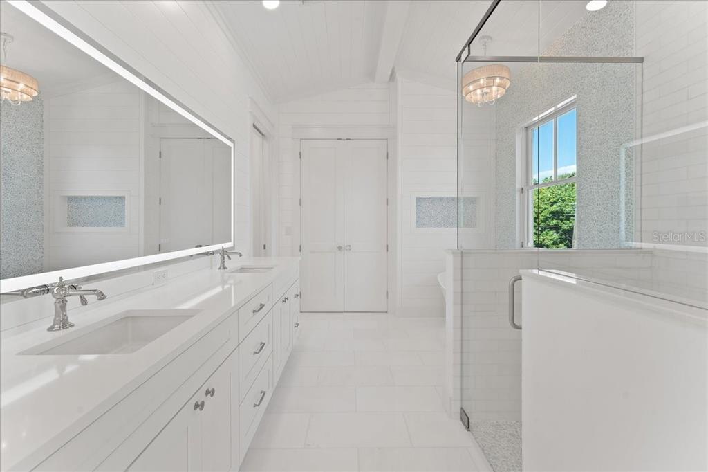847 Belcher Road Boca Grande, FL 33921 - Photo 30 of 74 a spacious bathroom with a double vanity sink a mirror and a shower