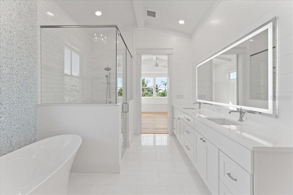 847 Belcher Road Boca Grande, FL 33921 - Photo 32 of 74 a bathroom with a double vanity sink a toilet and shower