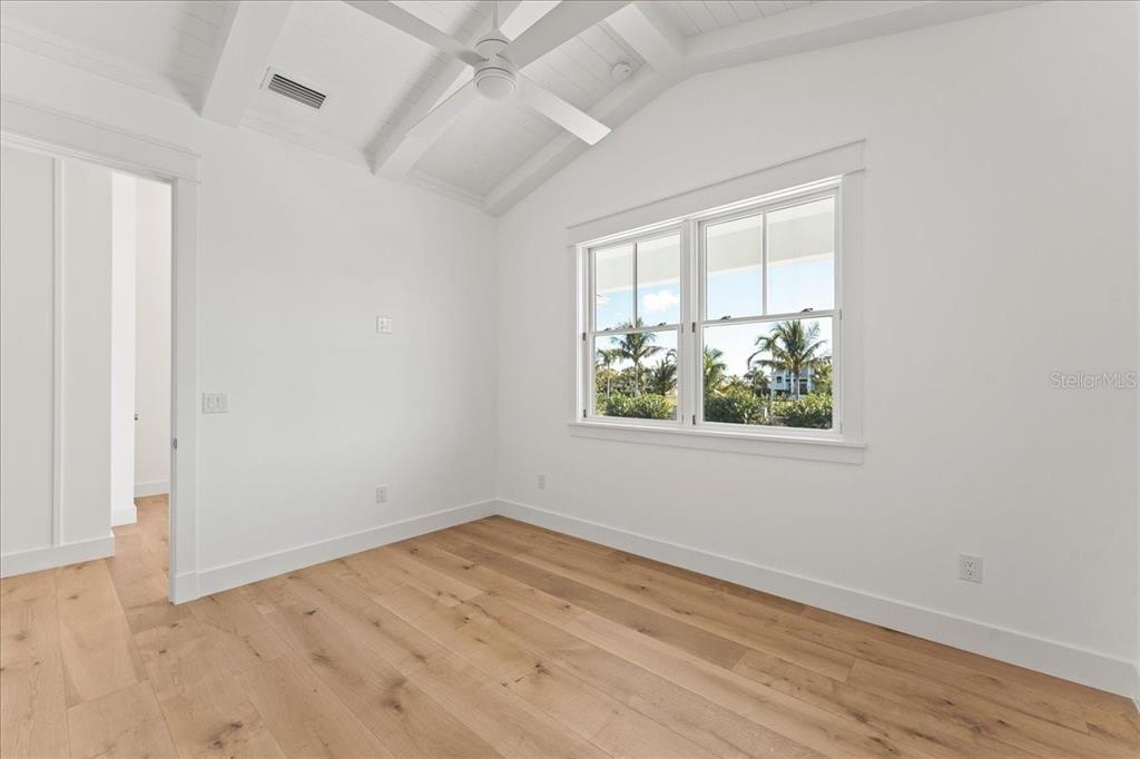 847 Belcher Road Boca Grande, FL 33921 - Photo 36 of 74 an empty room with wooden floor and windows