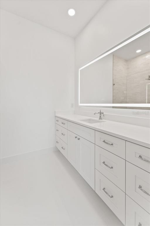 847 Belcher Road Boca Grande, FL 33921 - Photo 37 of 74 a bathroom with a double vanity sink and mirror