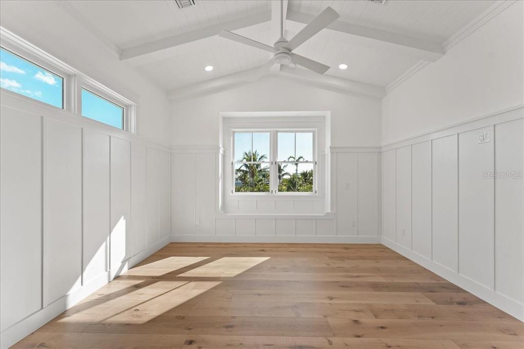 847 Belcher Road Boca Grande, FL 33921 - Photo 37 of 99 an empty room with wooden floor fan and windows