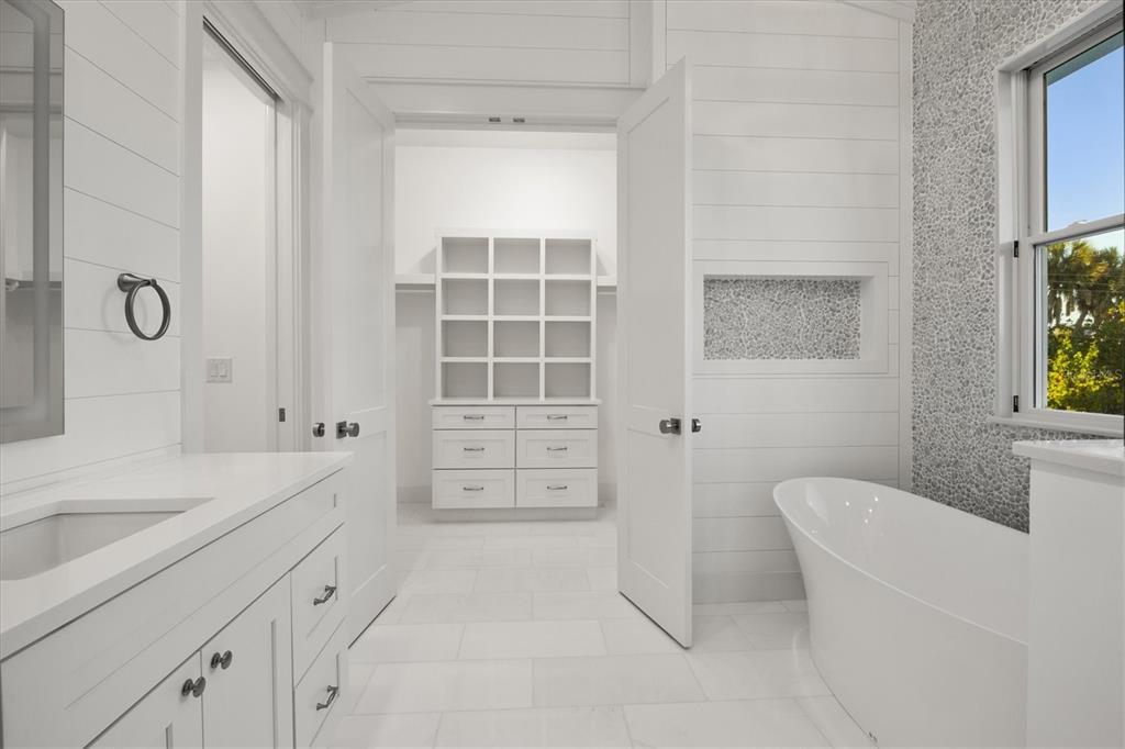 847 Belcher Road Boca Grande, FL 33921 - Photo 44 of 99 a bathroom with a tub sink and mirror