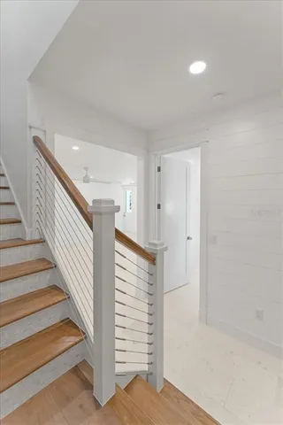 a view of a balcony with couch and potted plants