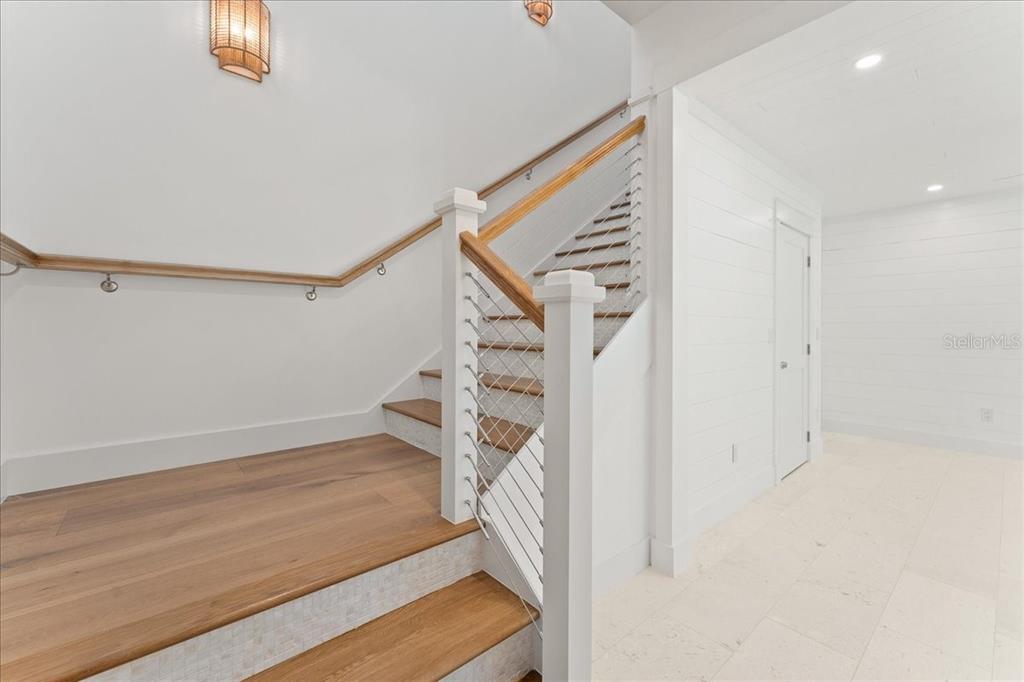 847 Belcher Road Boca Grande, FL 33921 - Photo 47 of 74 a view of an empty room with wooden floor and stairs