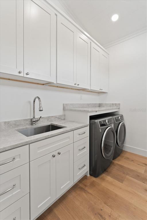 847 Belcher Road Boca Grande, FL 33921 - Photo 5 of 74 a kitchen with white cabinets and sink