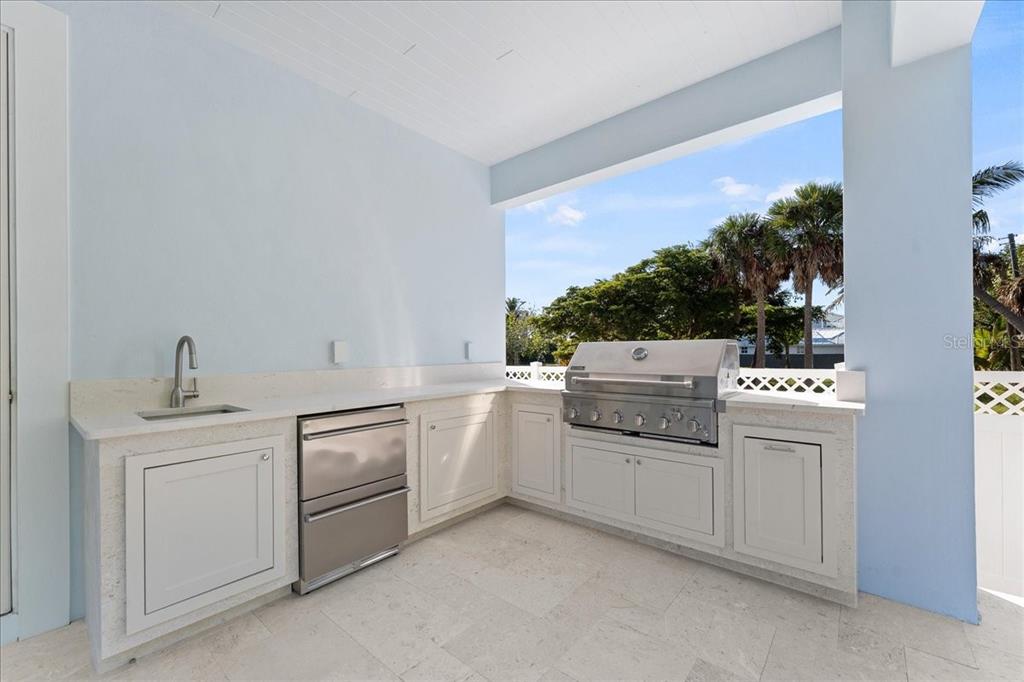 847 Belcher Road Boca Grande, FL 33921 - Photo 60 of 74 a kitchen with white cabinets and white appliances