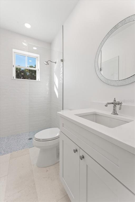 847 Belcher Road Boca Grande, FL 33921 - Photo 65 of 99 a bathroom with a sink a toilet and mirror