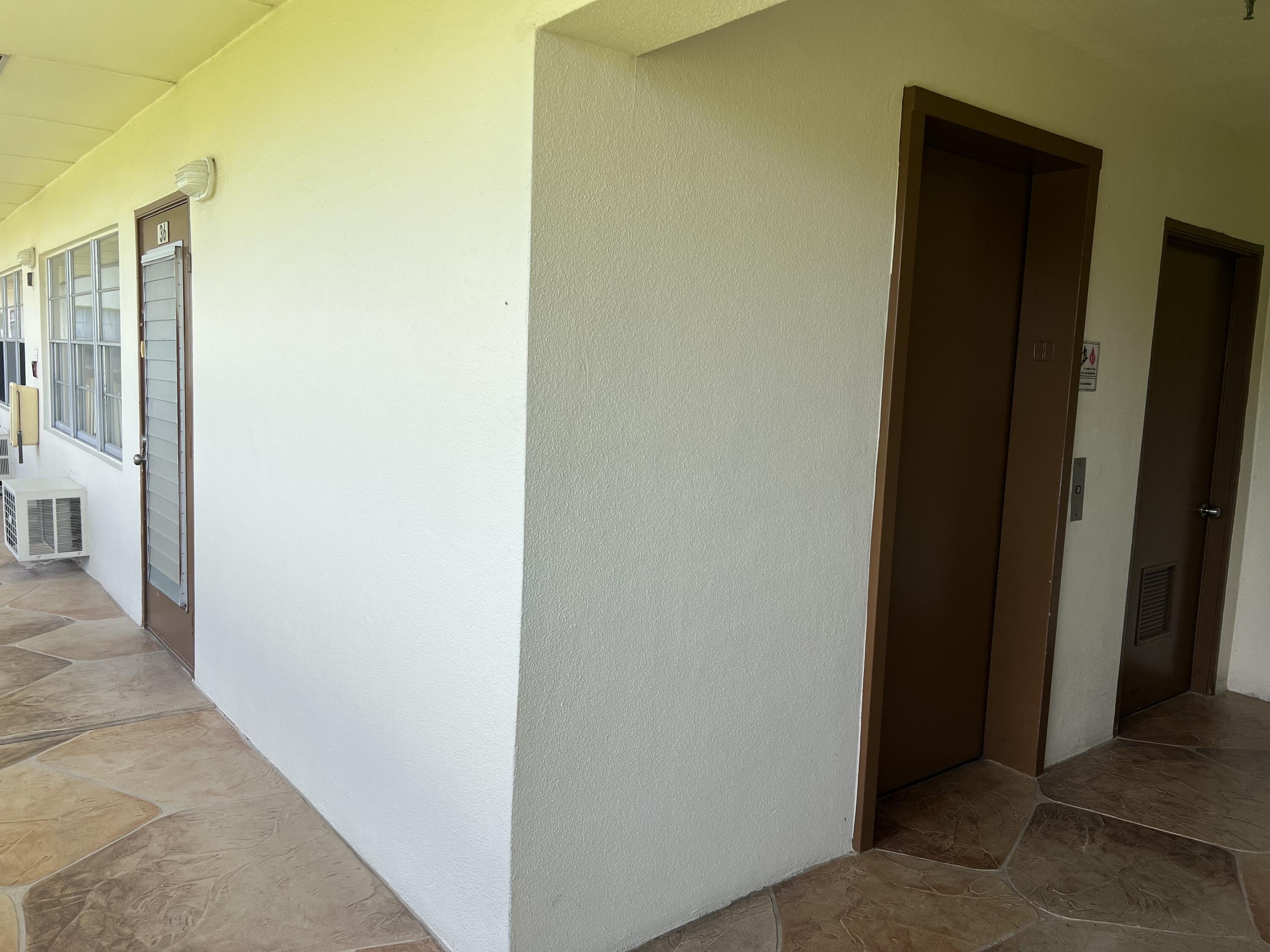 36 Mansfield B Boca Raton, FL 33434 - Photo 13 of 17 Front Door around Corner from Elevator I